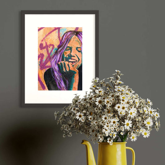 A framed artwork featuring a colorful abstract character with purple hair, displayed on a gray wall above a yellow vase with white flowers, next to a yellow teapot.