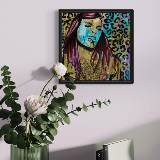 A canvas painting featuring a colorful, stylized portrait of a woman flipping the bird, set against a leopard print background, framed in a black frame.