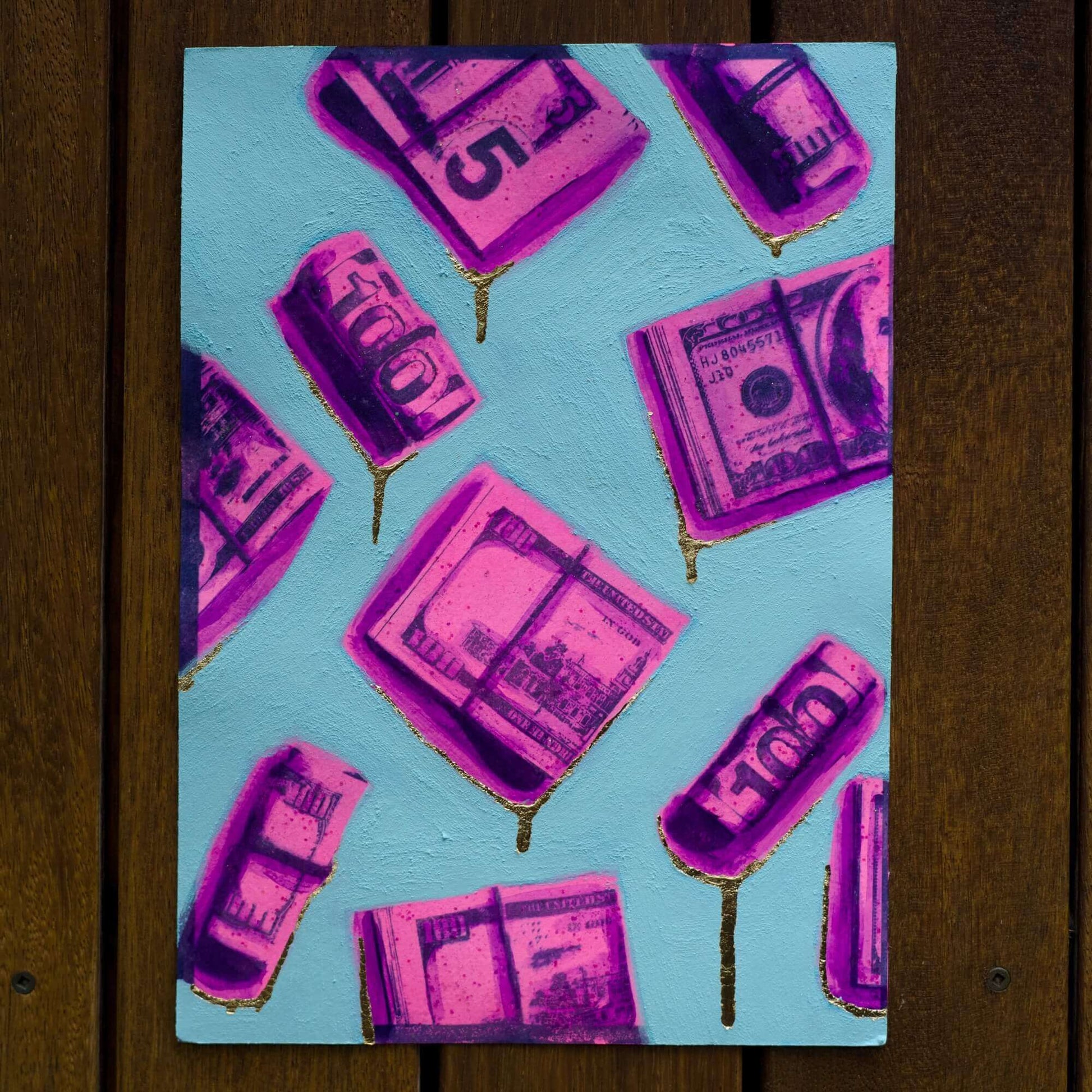 A framed painting featuring hot pink and purple dollar bills on a blue background