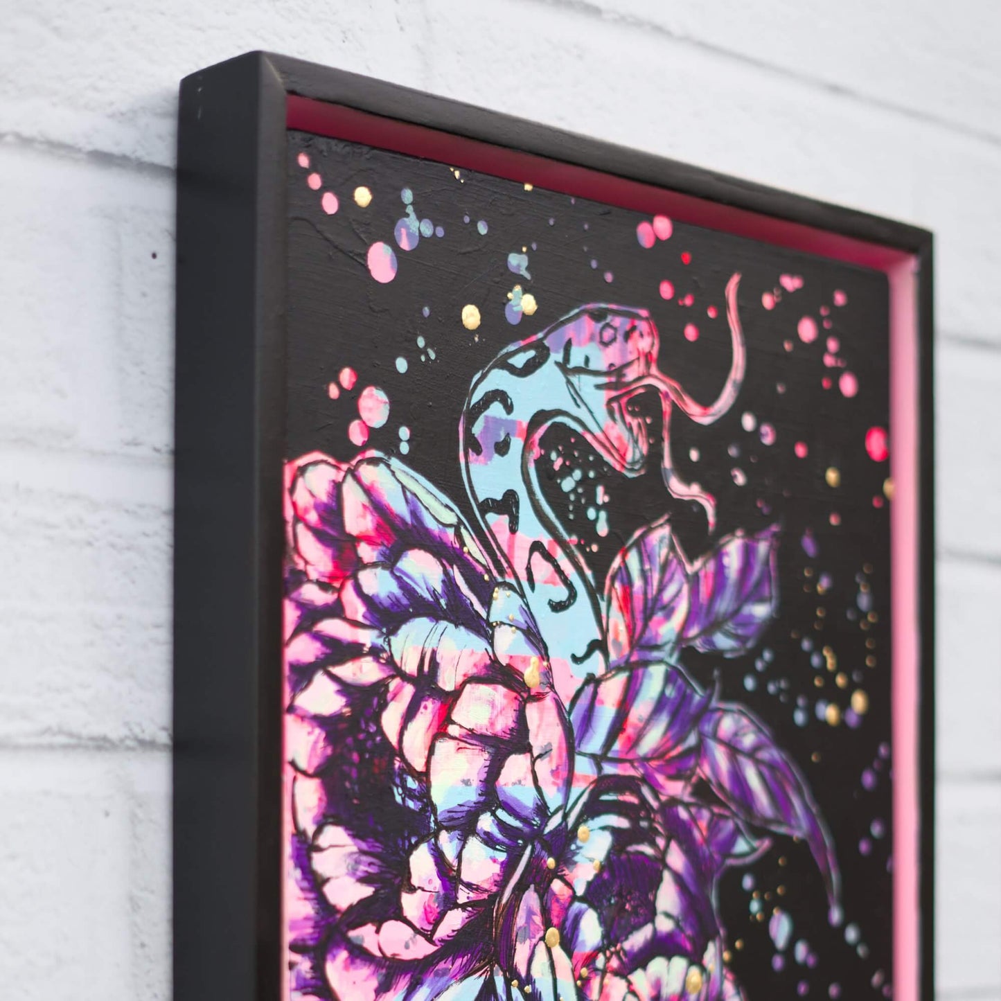 Bold floral and snake artwork in neon pink and gold on black, modern painting with edgy feminine energy