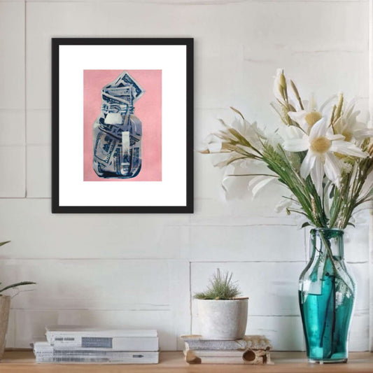 A mixed media painting featuring a stylized money jar in blue and white, framed in a black enclosure, displayed on a wall above a vase with flowers.