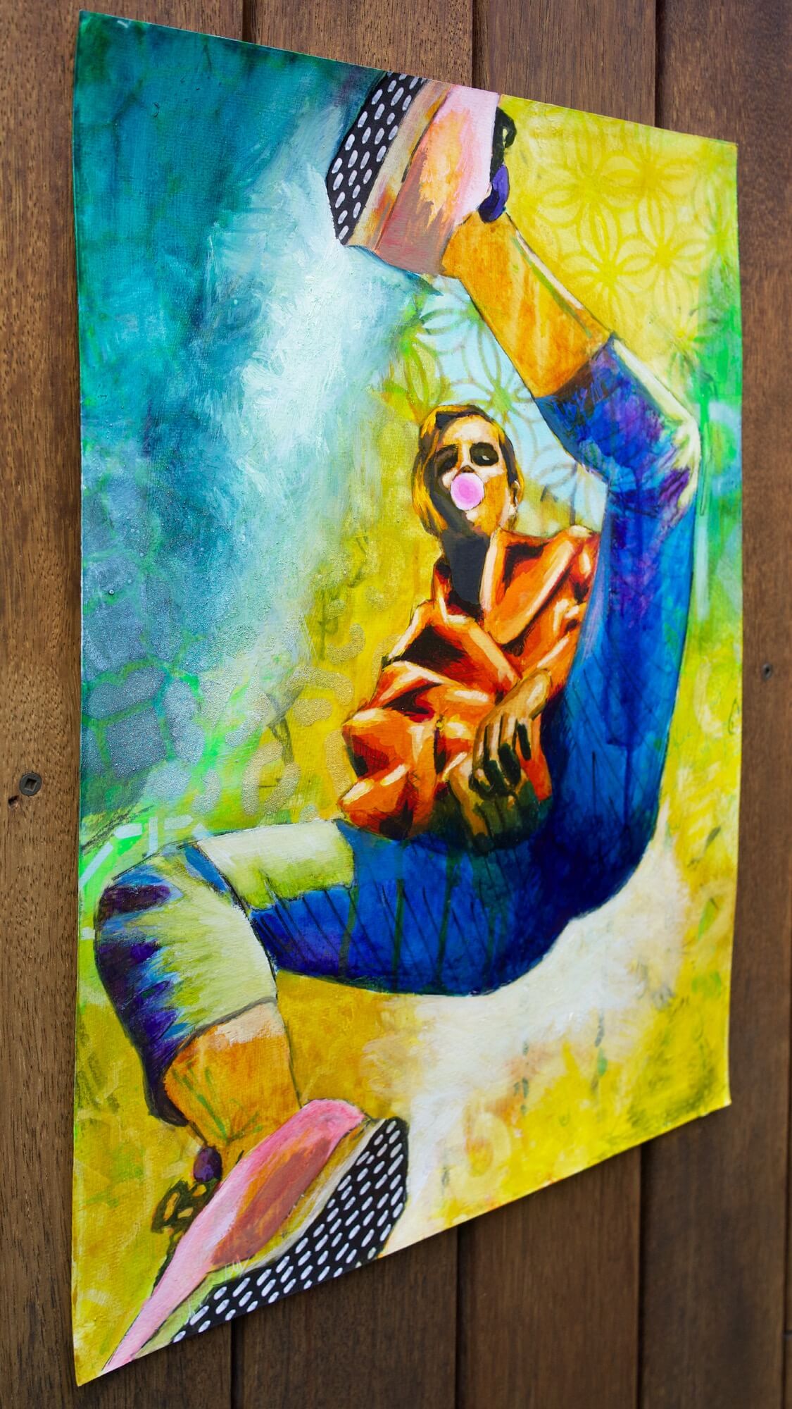 mixed media painting of a woman spinning in air in yellow and blue
