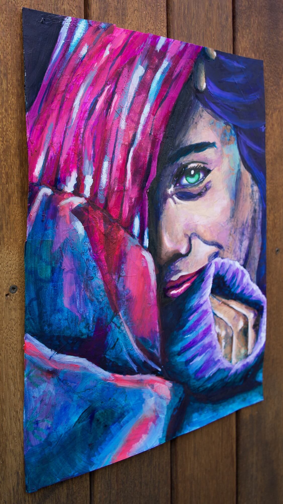 Mixed media painting of a woman wearing a sweater in pink and blue