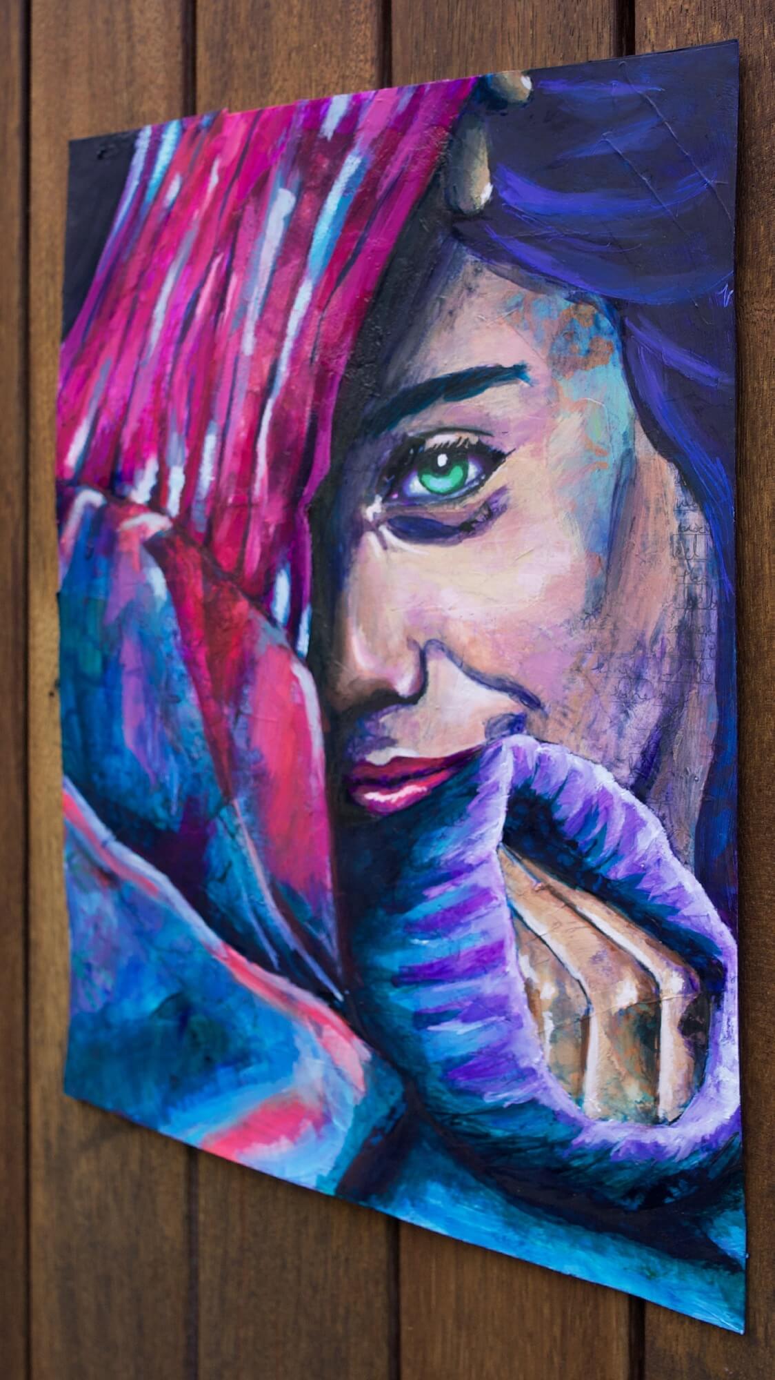 Mixed media painting of a woman wearing a sweater in pink and blue